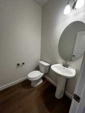 Bathroom featuring hardwood / wood-style flooring and toilet