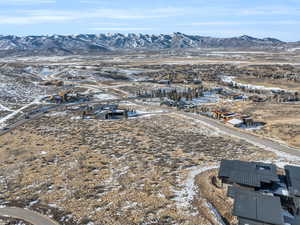 Snowy aerial view featuring a mountain view