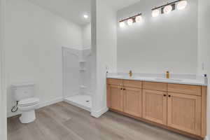 Basement bathroom with walk-in shower and double vanity.