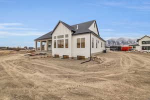 View of front of property featuring a mountain view and central air condition unit