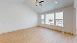 Unfurnished room featuring high vaulted ceiling, light hardwood / wood-style flooring, and ceiling fan