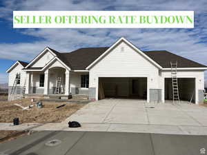 View of front of house with a porch and a garage