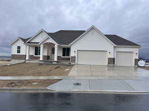 View of front of home featuring a garage and covered porch