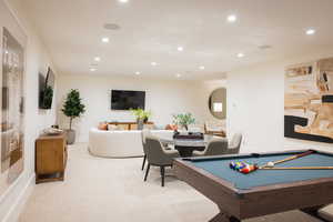 Recreation room with light carpet and billiards