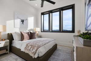 Bedroom featuring ceiling fan and light hardwood / wood-style flooring