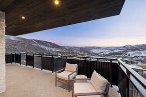 Snow covered back of property featuring a mountain view