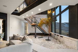 Living room featuring a mountain view and a towering ceiling