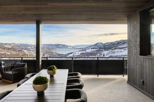 Interior space featuring a mountain view, wooden walls, carpet, and wood ceiling