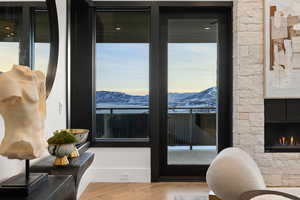 Entryway with a mountain view, hardwood / wood-style flooring, and a fireplace