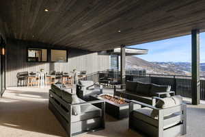 View of patio featuring a mountain view and an outdoor living space with a fire pit