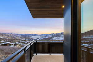 Snow covered back of property with a mountain view