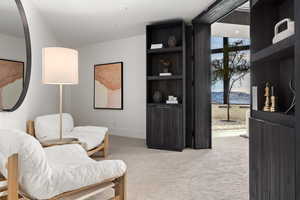 Sitting room with light carpet and a mountain view