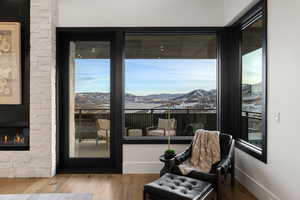 Sitting room with a mountain view, a fireplace, and hardwood / wood-style flooring