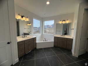 Bathroom with a mountain view, a washtub, and vanity