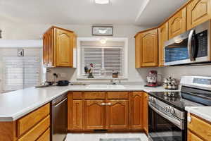 Kitchen with kitchen peninsula, sink, and stainless steel appliances