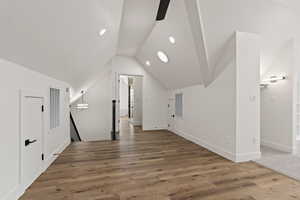 Bonus room featuring ceiling fan, hardwood / wood-style floors, and lofted ceiling