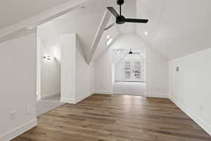 Additional living space with vaulted ceiling, ceiling fan, french doors, and dark hardwood / wood-style floors