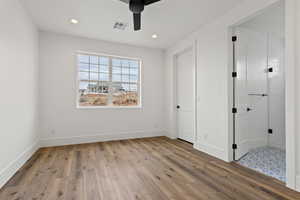 Unfurnished bedroom with ceiling fan and light hardwood / wood-style flooring