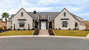 French country style house with a front lawn