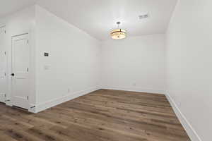 Spare room with dark hardwood / wood-style flooring