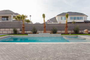 View of swimming pool featuring an in ground hot tub