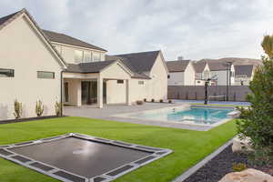 View of swimming pool with a patio area, an in ground hot tub, and a yard