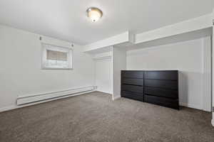 Interior space with carpet and baseboard heating