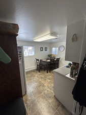 Interior space featuring plenty of natural light, white fridge, and a textured ceiling