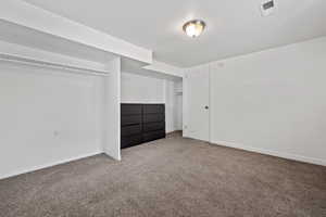 Unfurnished bedroom featuring carpet flooring and a closet