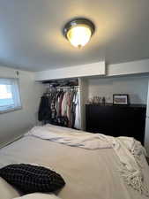 Bedroom featuring a textured ceiling and a closet