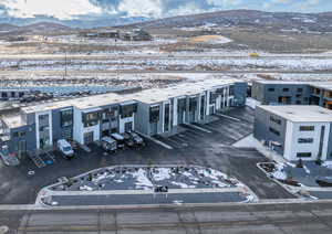 Snowy aerial view featuring a mountain view