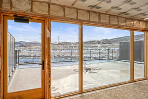 Doorway to outside with a mountain view and plenty of natural light