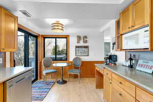 Kitchen featuring dishwasher, light wood-type flooring, and a textured ceiling