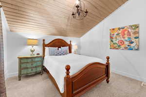 Bedroom featuring light colored carpet, lofted ceiling, and wooden ceiling