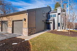 View of front of property featuring a front lawn and a garage