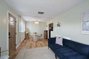 Living room with hardwood / wood-style floors and a chandelier