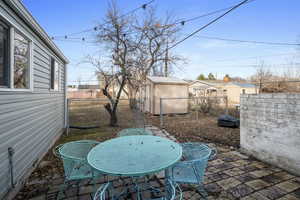 View of patio / terrace featuring a storage unit