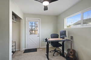 Office area featuring light carpet and ceiling fan