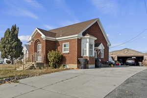 View of property exterior with an outdoor structure and a garage