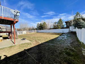 View of yard with a patio, an outdoor fire pit, and a wooden deck