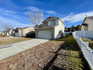 View of home's exterior with a yard and a garage