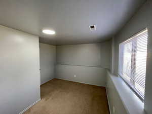 Spare room featuring carpet flooring