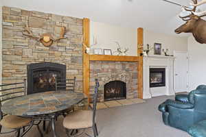 Living room with a fireplace and carpet flooring