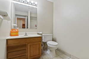 Bathroom with tile patterned floors, vanity, and toilet