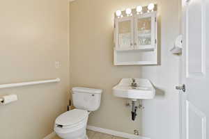 Bathroom featuring tile patterned flooring and toilet