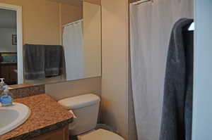 Bathroom with vanity and toilet and shower