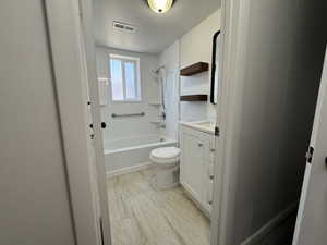 Full bathroom featuring vanity, toilet, and shower / bathtub combination