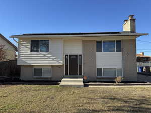 Back of house featuring a lawn