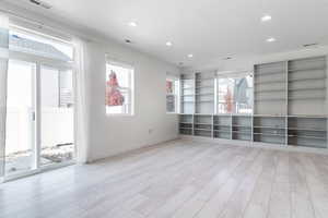 Spare room featuring plenty of natural light and light wood-type flooring