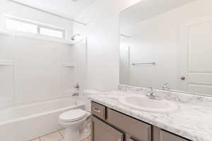 Full bathroom featuring tile patterned flooring, shower / bathing tub combination, vanity, and toilet